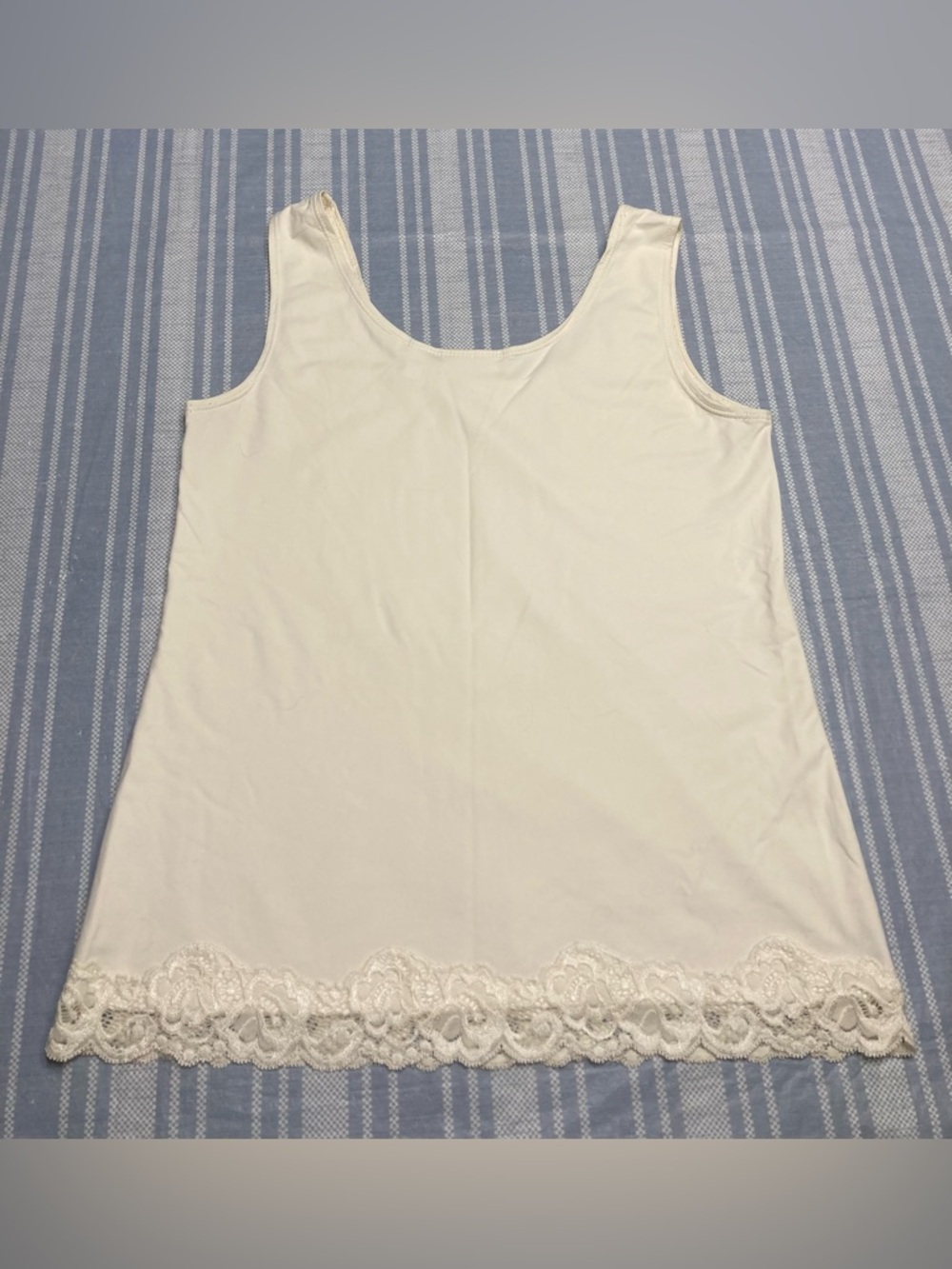 Chico's cream colored tank top with lace detail on hem.